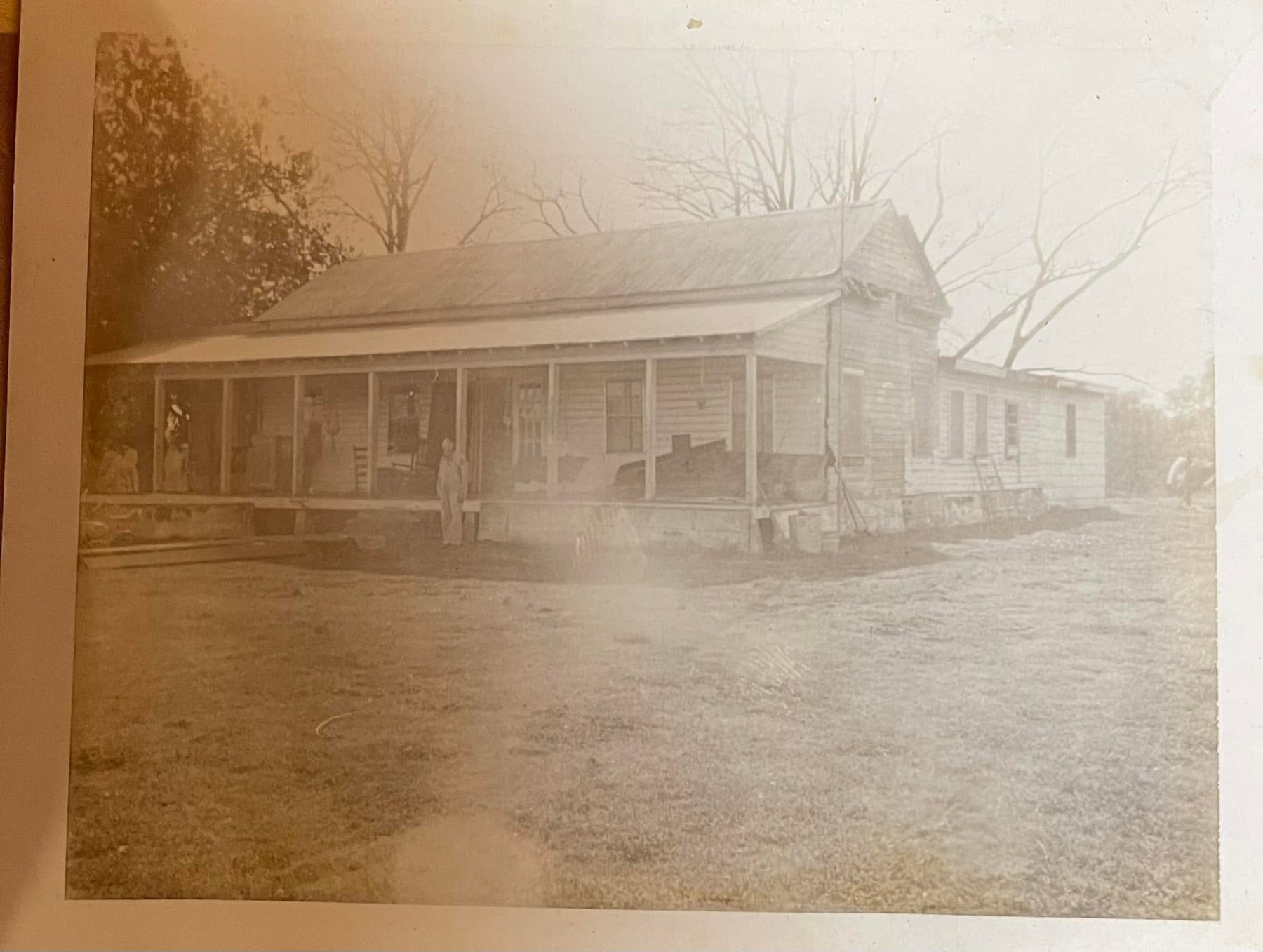 Sepia historical view of the Whiteman home and porch
